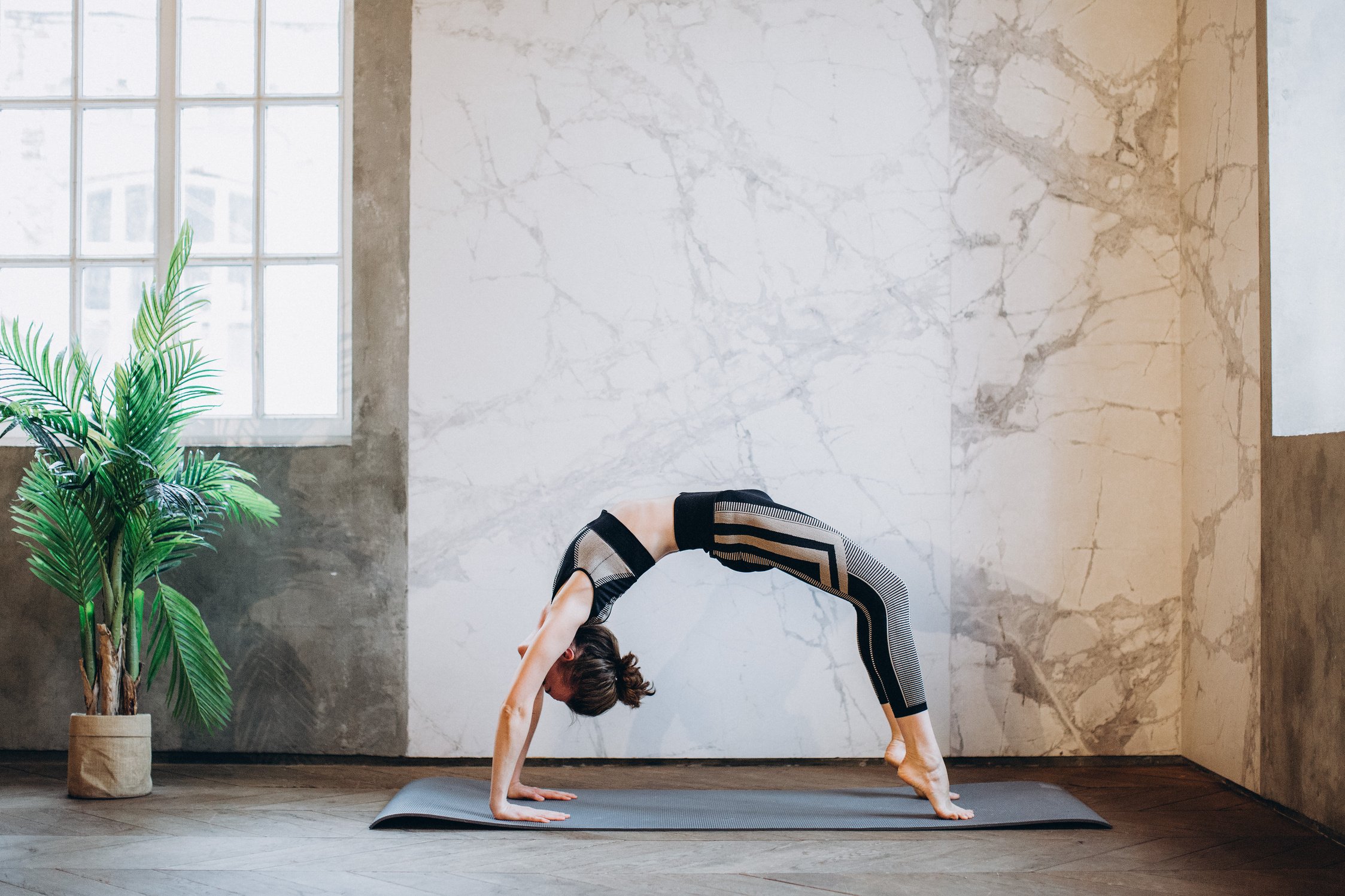 Woman in Black Sports Bra and Black Leggings Doing Yoga